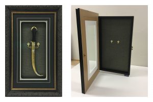 Framed-Hinged-Cabinet-with-Ornate-Dagger